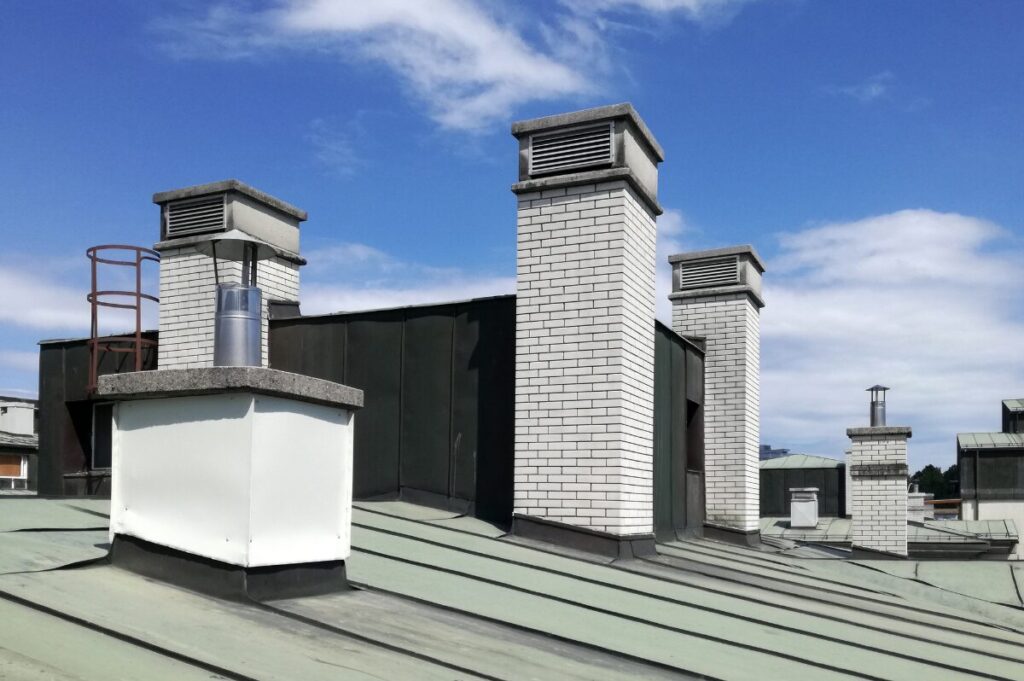 View of a commercial rooftop with air vents and ladders for access