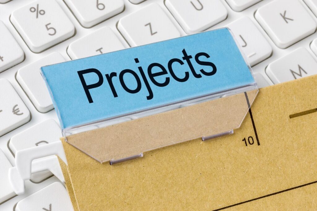 A brown manilla file with a blue label that says Projects on it